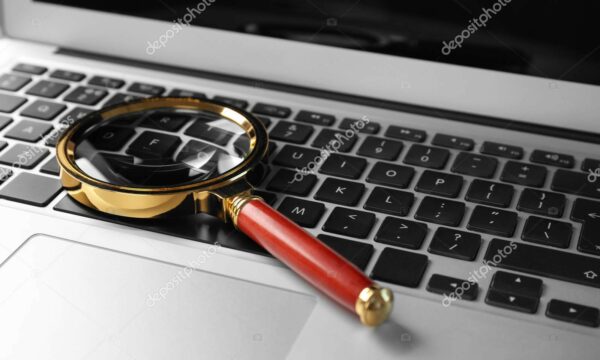 Magnifying glass on laptop. Internet search concept