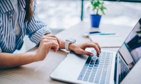 Cropped image of female hands searching web information during social networking via modern laptop computer, woman connecting to wifi wireless for making online netbook booking and banking