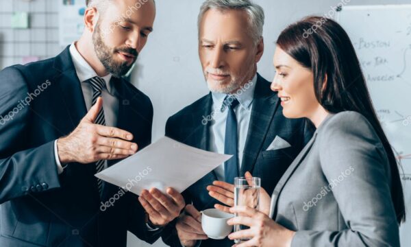 businessman pointing paper smiling businesswoman